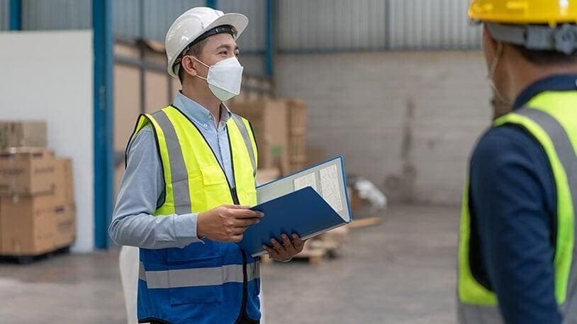 OHS consultant reviewing a safety file at REH Safety Training